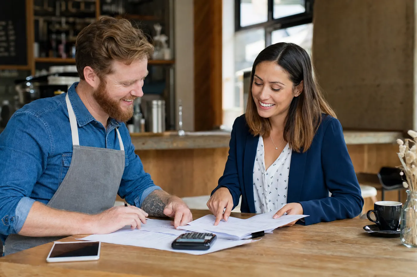 Broker reviewing card terminal statements with a cafe owner